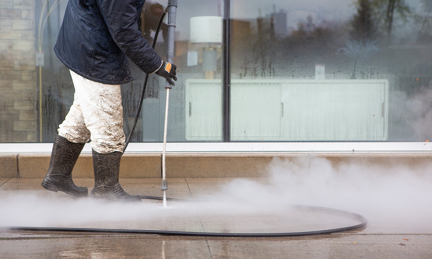 Powerful Pressure Washer Using to Clean Business Front
