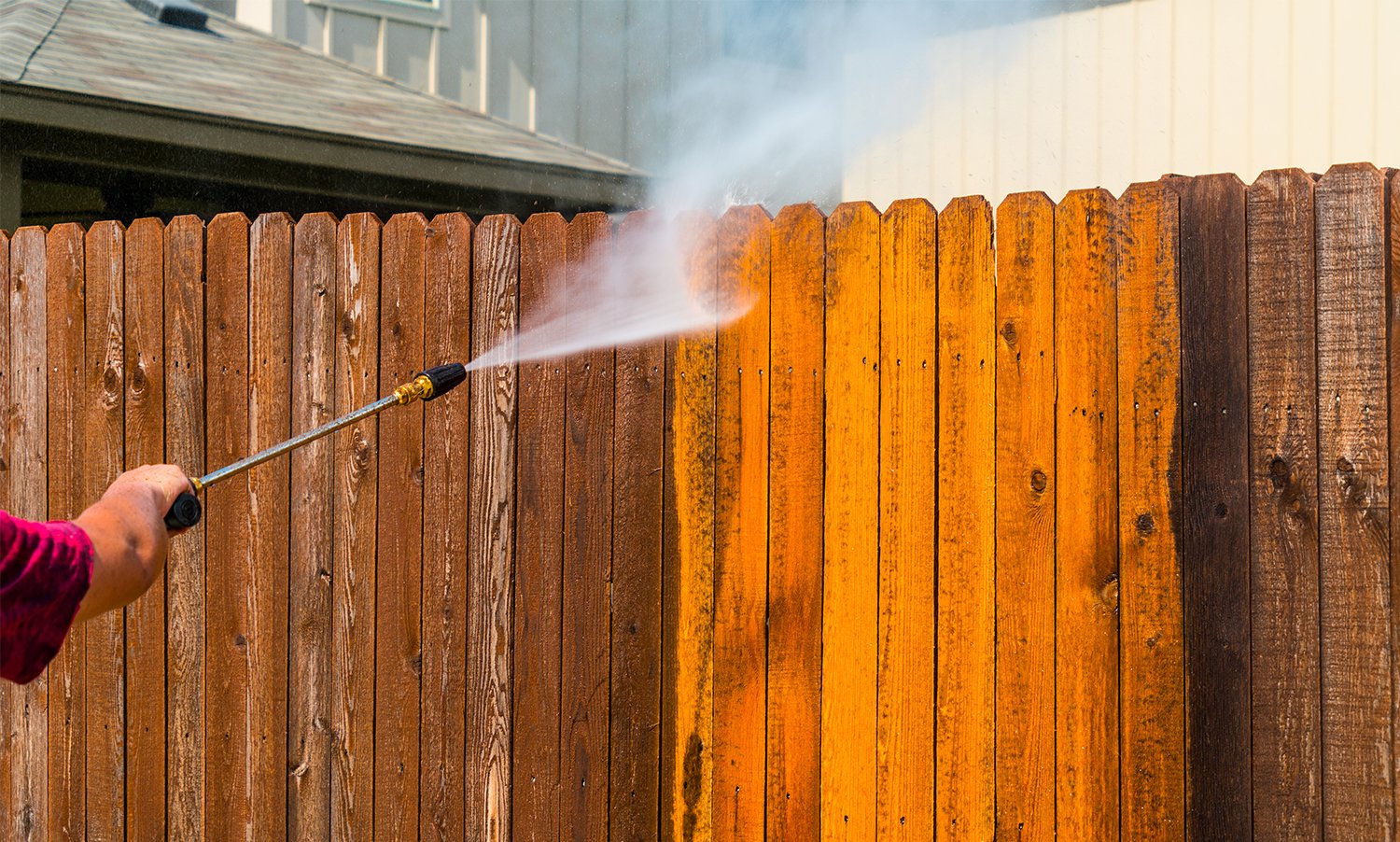 Powerful Pressure Washer Using to Clean Dirty Fence