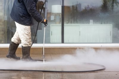 Powerful Pressure Washer Using to Clean Business Front